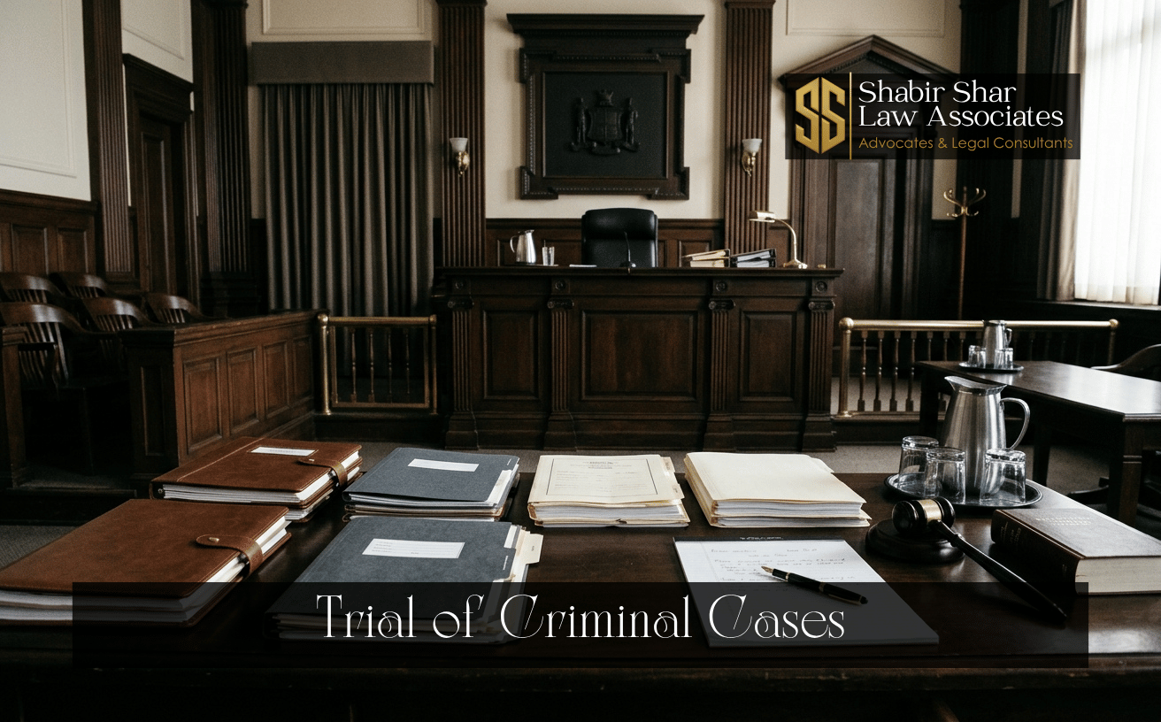Courtroom counsel table and case files representing criminal trial proceedings in Karachi